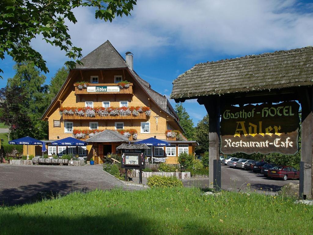 a large building with a sign in front of it at Hotel Adler Bärental in Feldberg