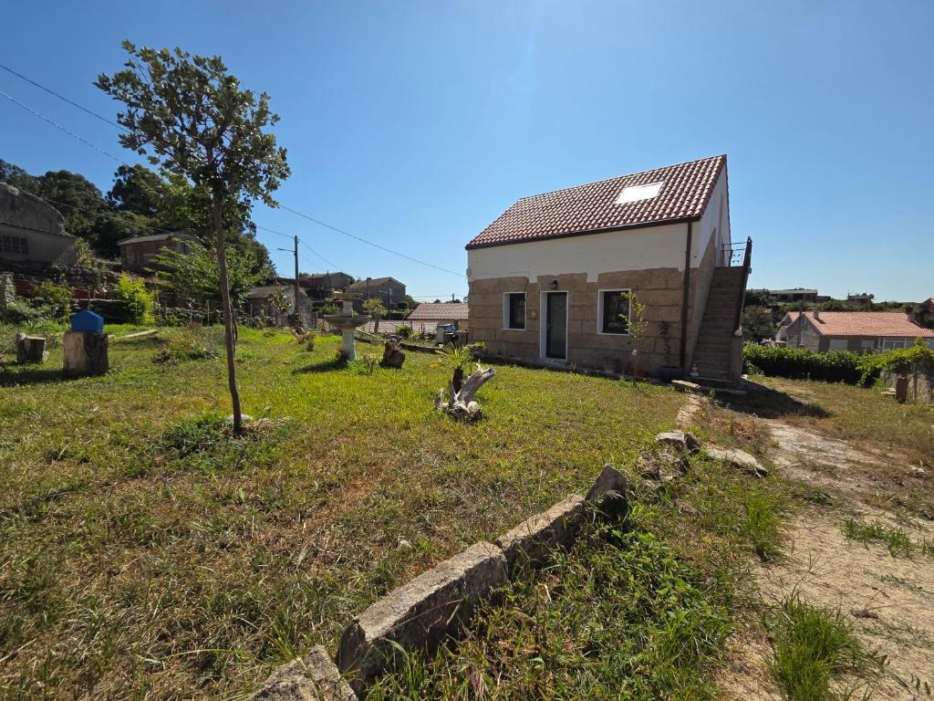 ein kleines Haus mitten auf einem Feld in der Unterkunft A Casa De Margó, casa con encanto en O Grove in San Vicente do Mar