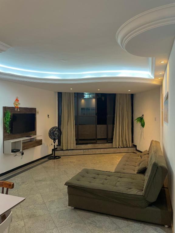 a living room with a couch and a flat screen tv at Ap Beira mar na Orla in Aracaju