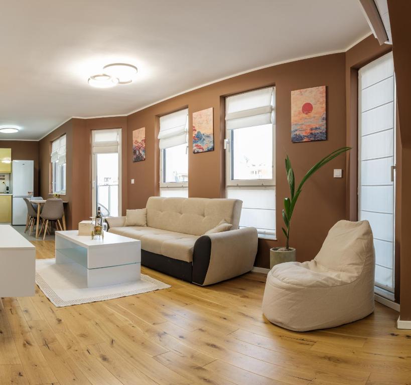 een woonkamer met een bank en een tafel bij Heart & Honey - The Romantic Loft in Plovdiv