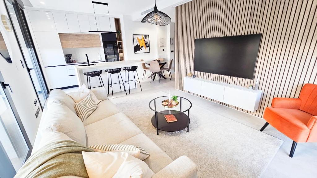 a living room with a couch and a tv at Casa Soluna -Santa Rosalia Lake and Life Resort in Torre-Pacheco