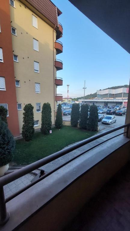 a window with a view of a parking lot at Apartman Dona in Jagodina