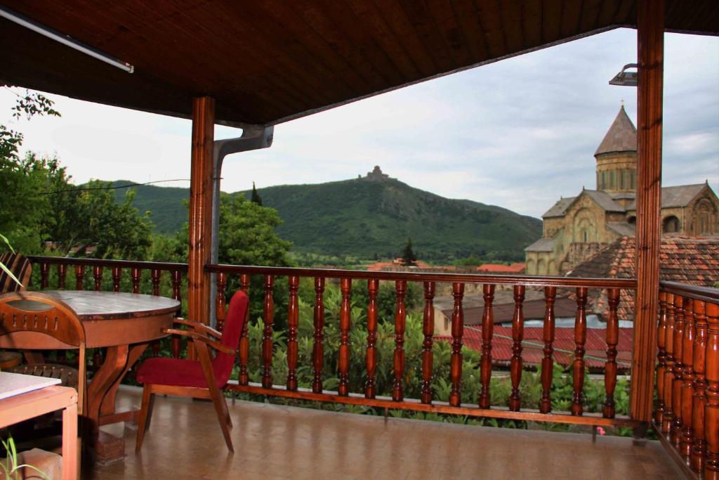 a balcony with a table and chairs and a view at Hotel Queen in Mtskheta