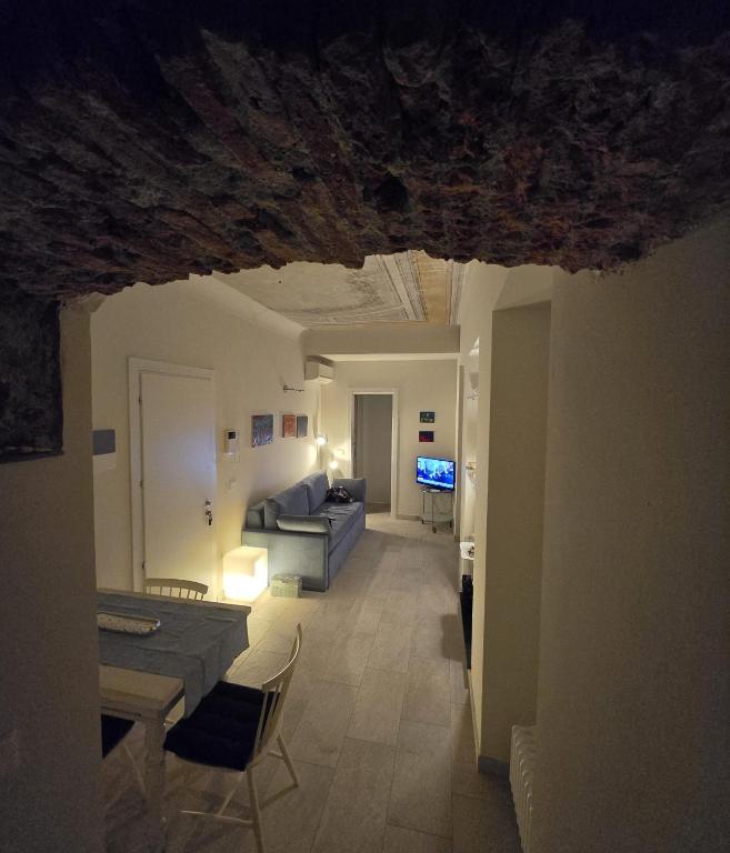 a living room with a couch and a table at Casa Edoardo tra Budello e Mare in Alassio