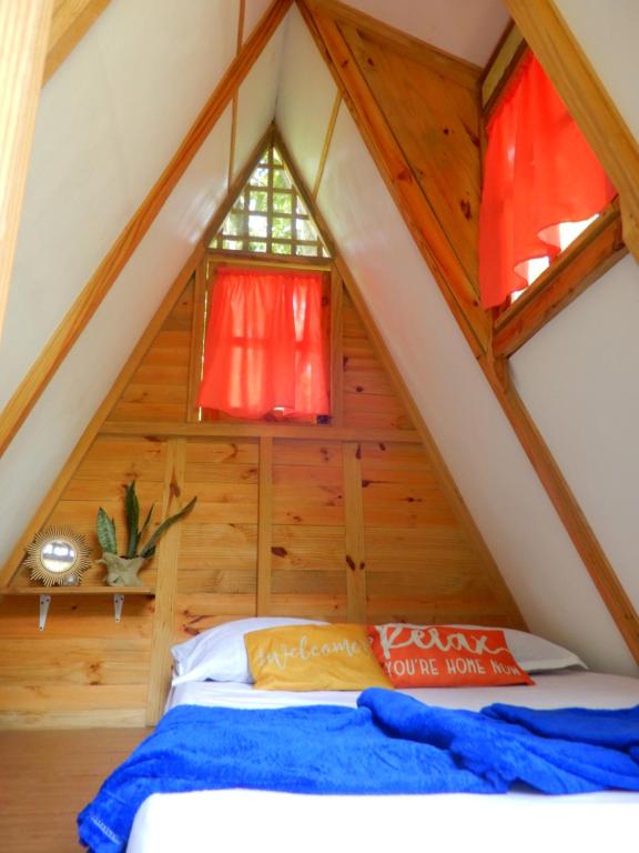 a bed in the attic of a tree house at Eco Camping Jarabacoa in Jarabacoa