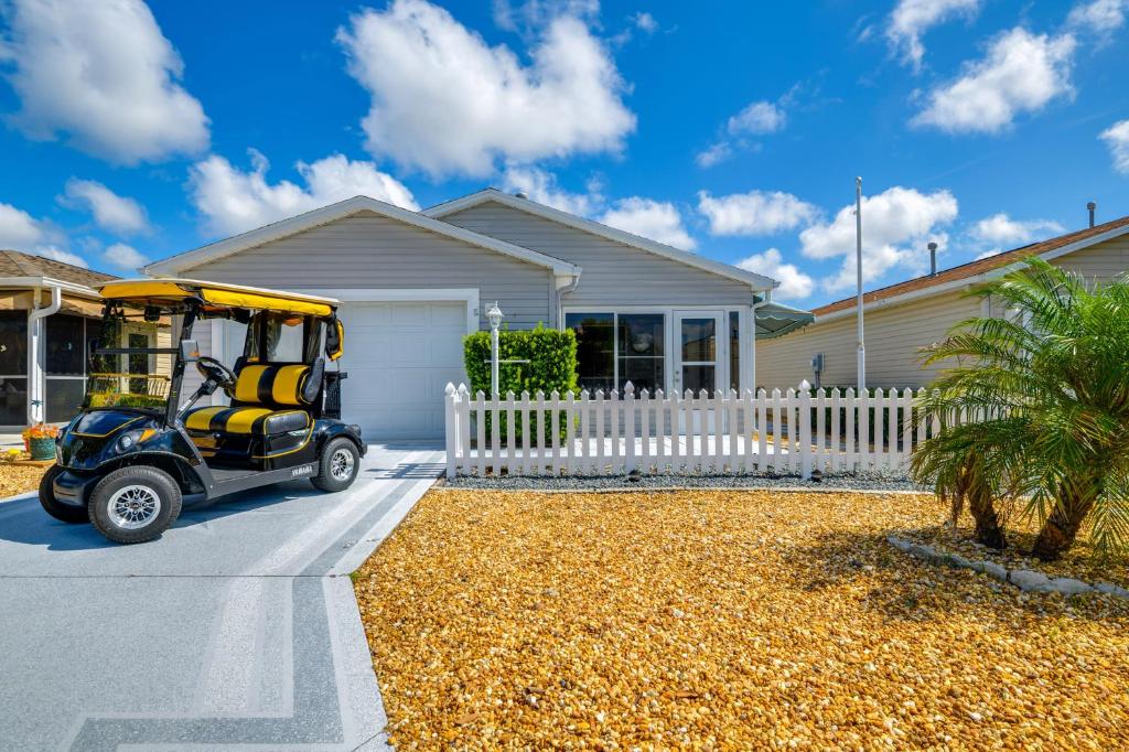 a golf cart parked in front of a house at 4 Mi to Lake Sumter Landing Home in The Villages in The Villages