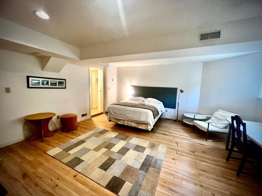 a bedroom with a bed and a table in it at Beautiful and cozy room in Vancouver in Vancouver