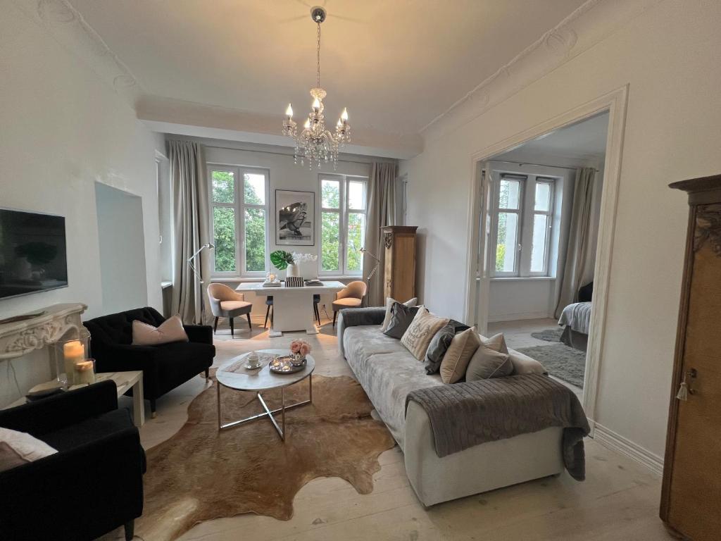 a living room with a couch and a table at APARTAMENT PARYSKI, Centrum Słupsk in Słupsk