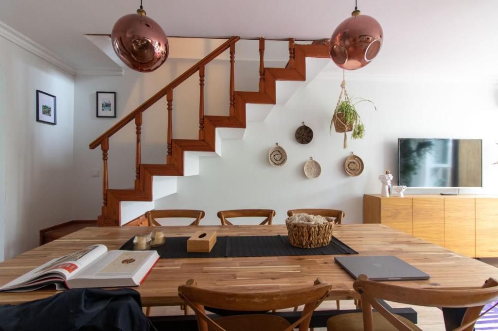 a dining room with a wooden table and stairs at 3BR Villa with Garden & Terrace in Kadikoy in Istanbul