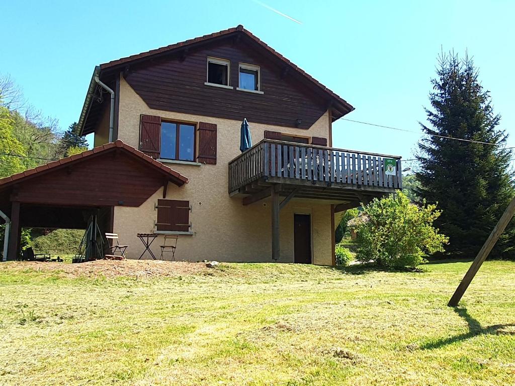 a house with a balcony on top of it at Chalet familial Vosges avec baby-foot et animaux admis - FR-1-589-688 in Ventron