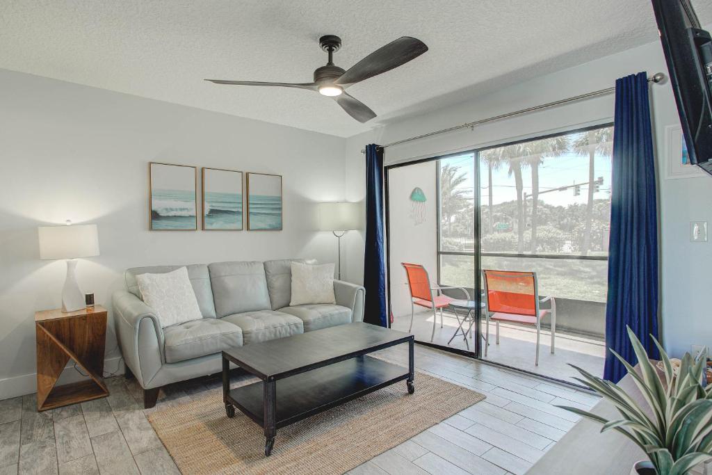 a living room with a couch and a table at Ocean Side Complex with Heated Pool B-15 in Saint Augustine