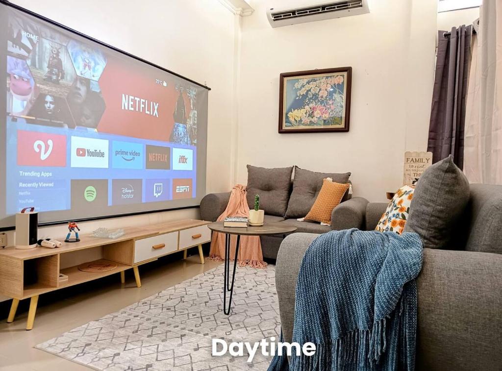 a living room with a large flat screen tv at 3Bed&Bath family friendly house in Davao City