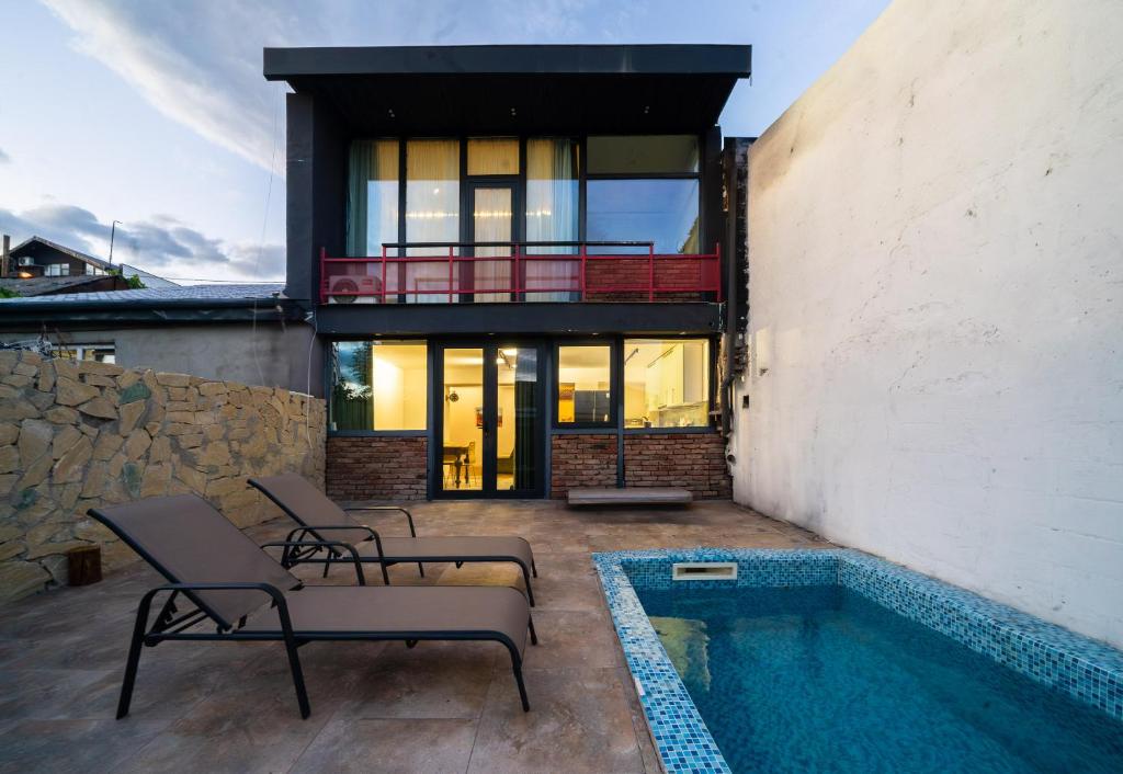 a house with a swimming pool next to a building at Niabi Villa with pool in Tbilisi City