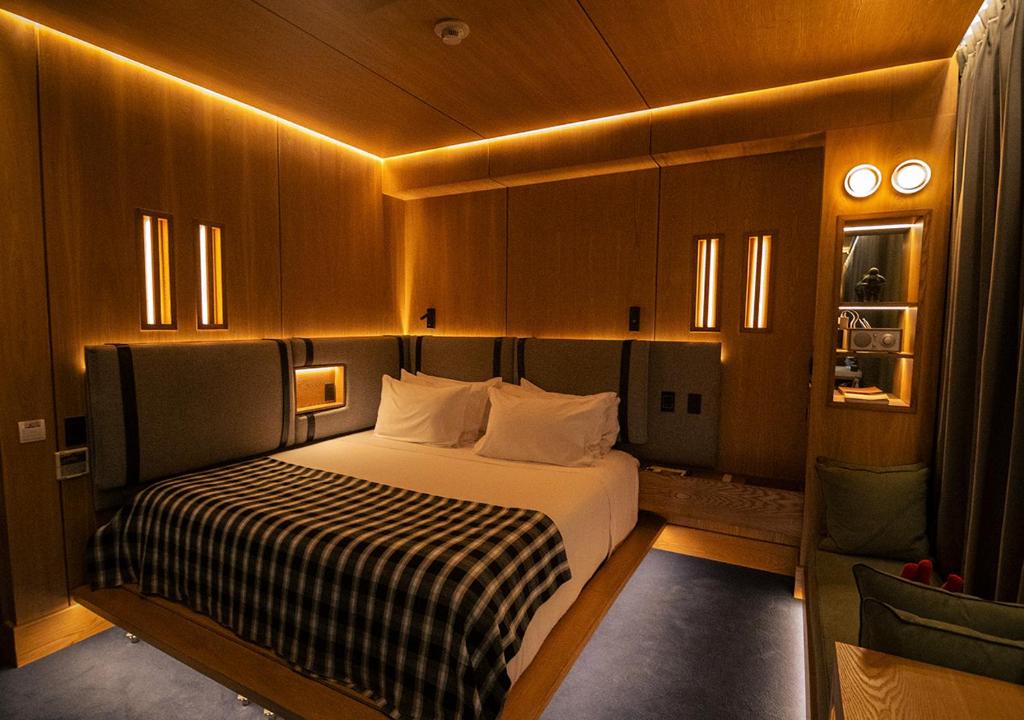 a bedroom with a bed with a black and white blanket at The Click Clack Hotel Bogotá in Bogotá