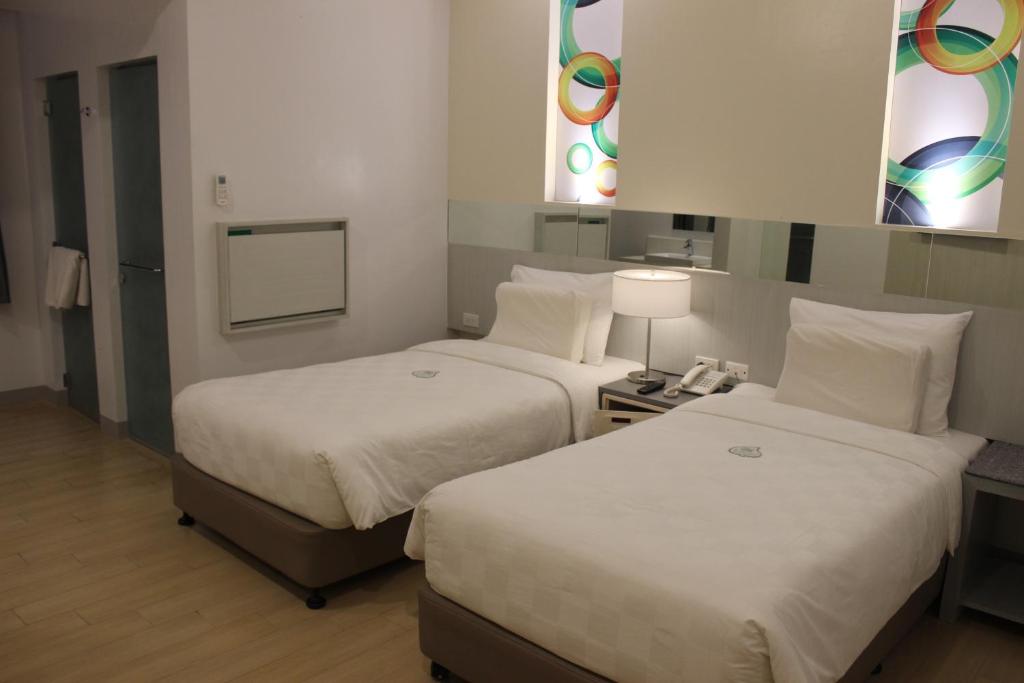 Postel nebo postele na pokoji v ubytování Go Hotels Butuan