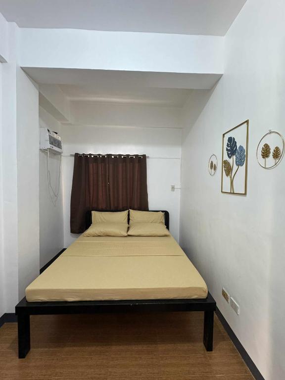 a small bedroom with a bed in a room at GLC Tourist Inn in Coron