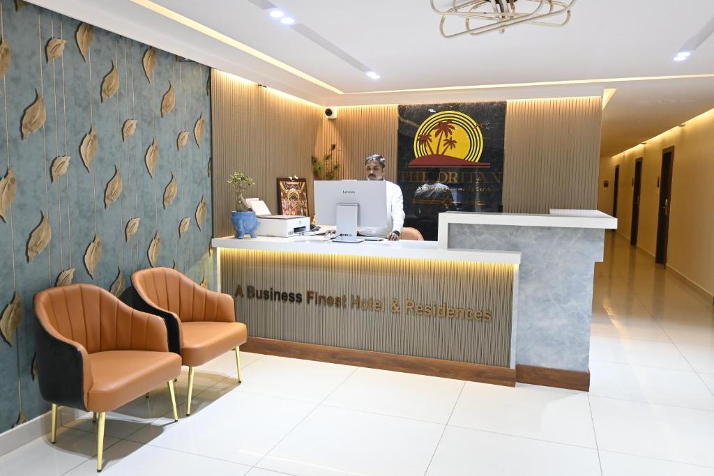 a waiting area with two chairs and a counter in a store at The Dritan Brookefield ITPL Main Road in Bengaluru