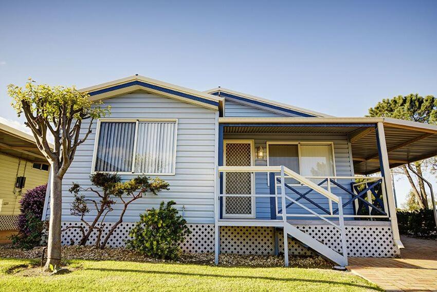 a house with a staircase in the front of it at Wavecrest Village & Tourist Park in Hopetoun