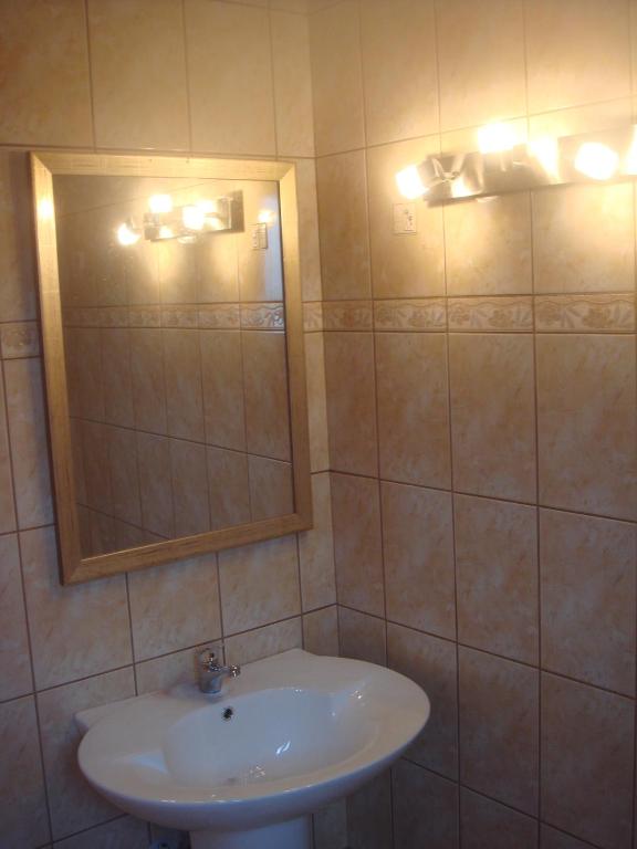 a bathroom with a sink and a mirror at Alessandro in Sidari