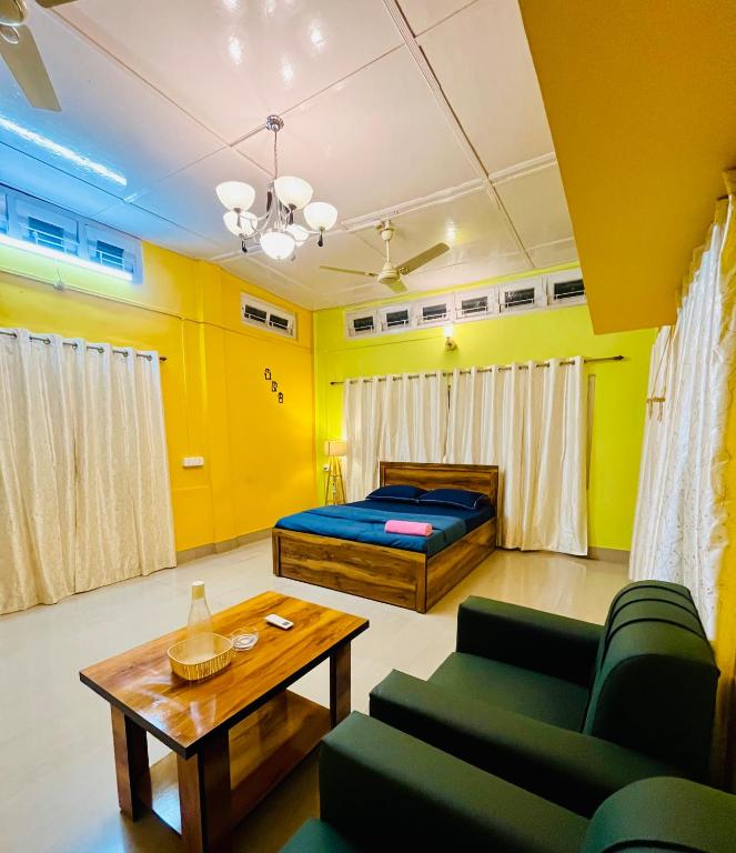 a living room with a bed and a table at Bloom homestay in Guwahati
