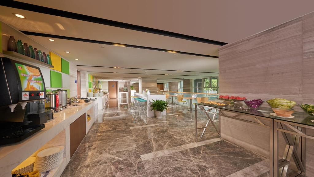 a large room with a bar in a building at Holiday Inn Express Hangzhou Huanglong in Hangzhou