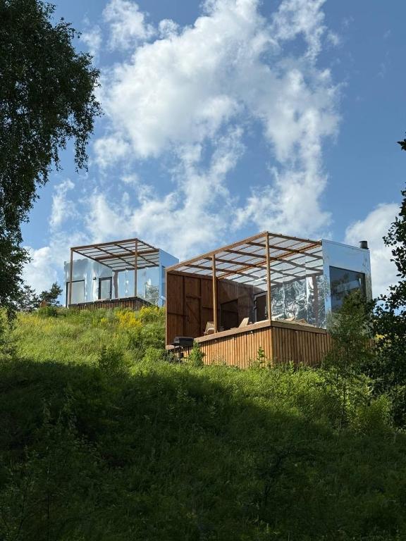 a house on top of a grassy hill at Дзеркальний будинок Botan in Malaya Bugayevka