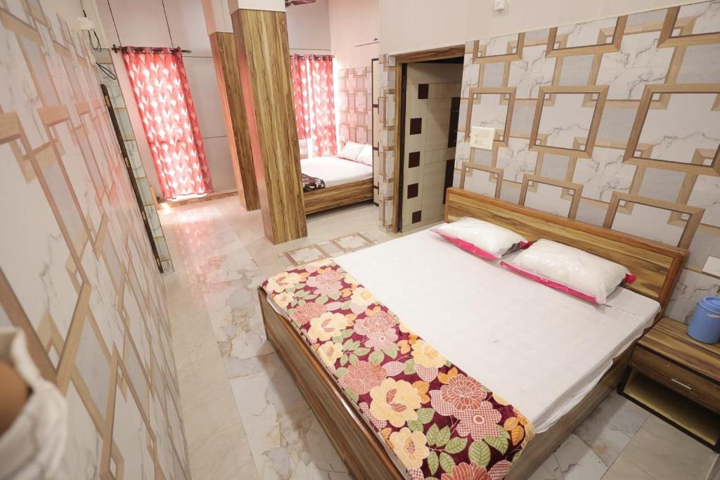 a bedroom with a bed in a room with a mirror at Kalindi Blessings Deluxe Guest House in Mathura