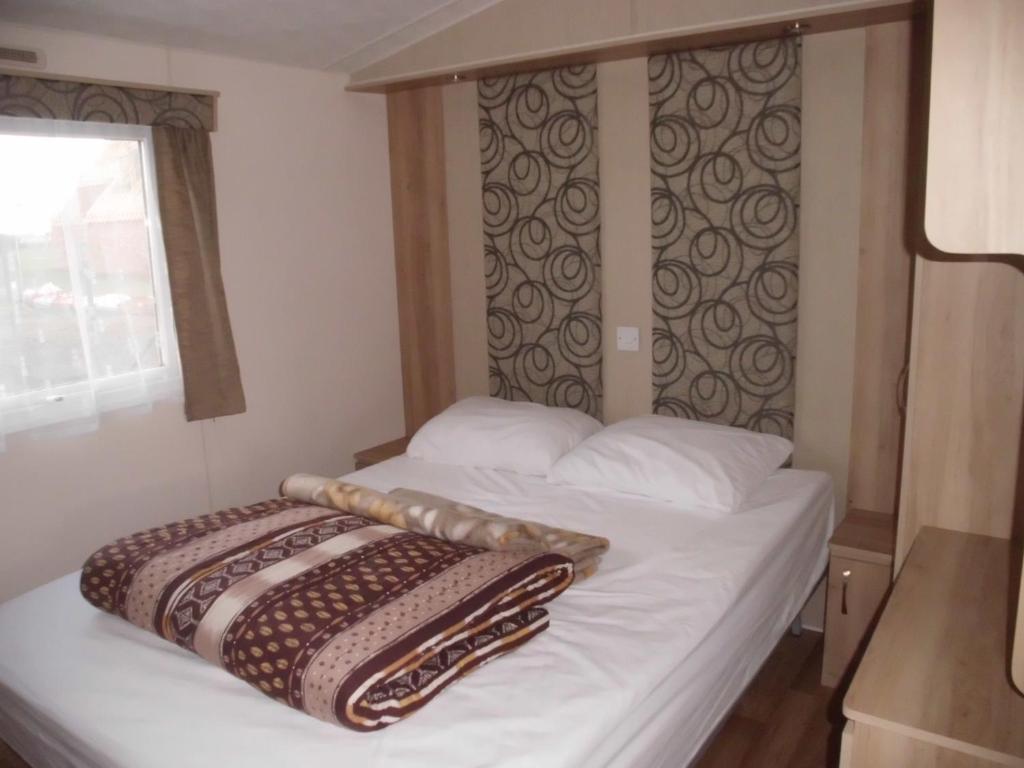 una camera con un letto con due cuscini sopra di Camping Ter Hoeve a Bredene
