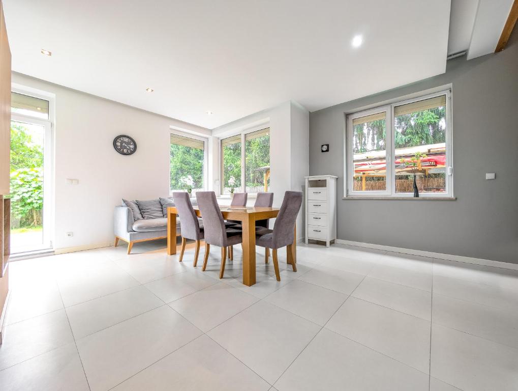 a dining room with a table and chairs at Trawowa Spacious House by BookingHost in Wrocław