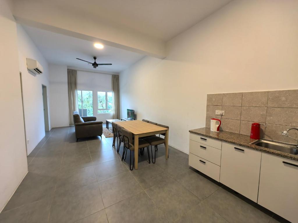 a kitchen and dining room with a table and a dining room at Simfoni Comfy Premium 03 in Langkawi Islands