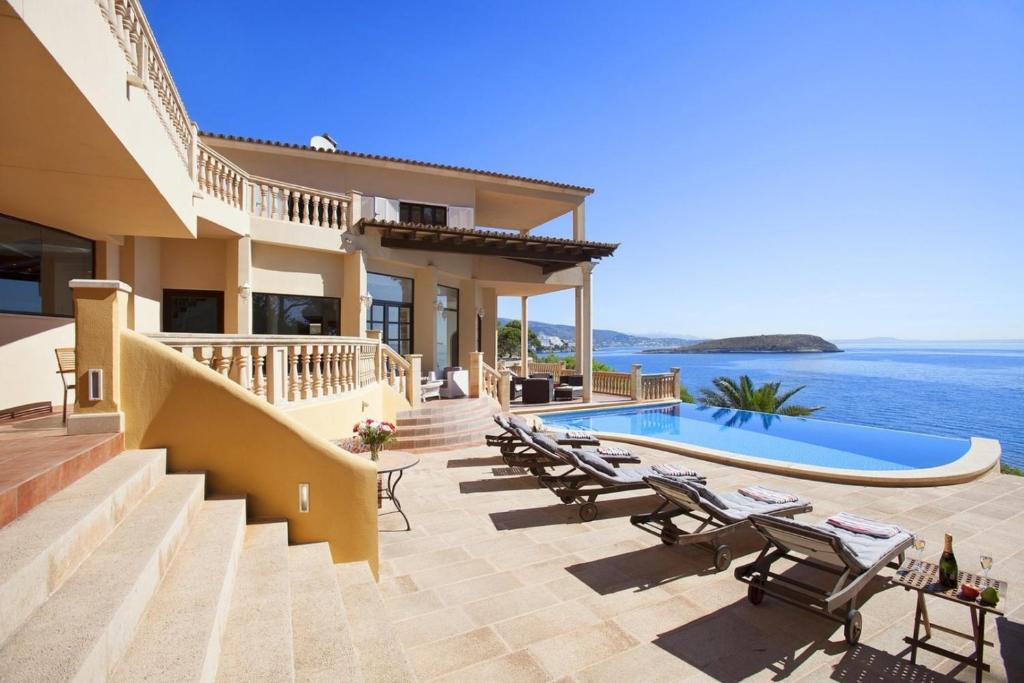a villa with a view of the ocean at Escape to Luxury: Rent Mallorca Villa 1452 in Cala Vinyes