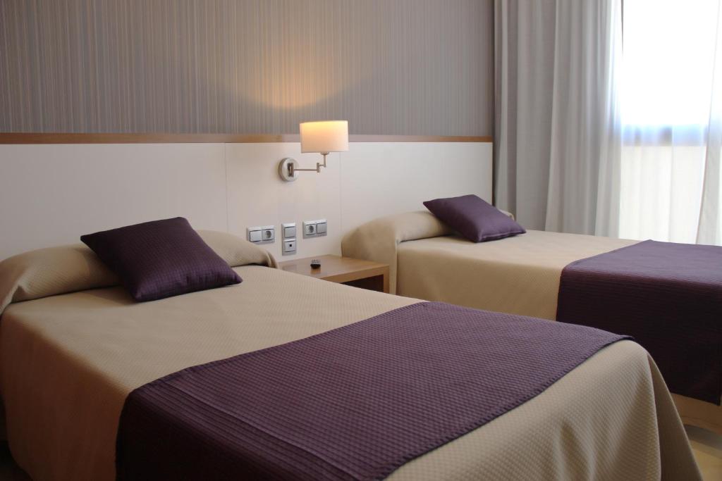 Cama o camas de una habitación en Hotel Teruel