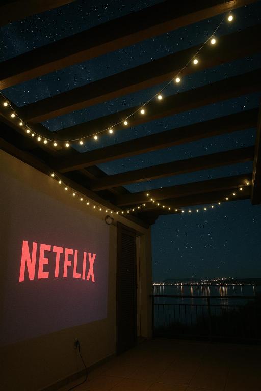a netflix sign on a wall with lights at Villa Oleander by Domus Mirus - Rooftop Cinema & Pool & 6min Walk to Beach in Splitska