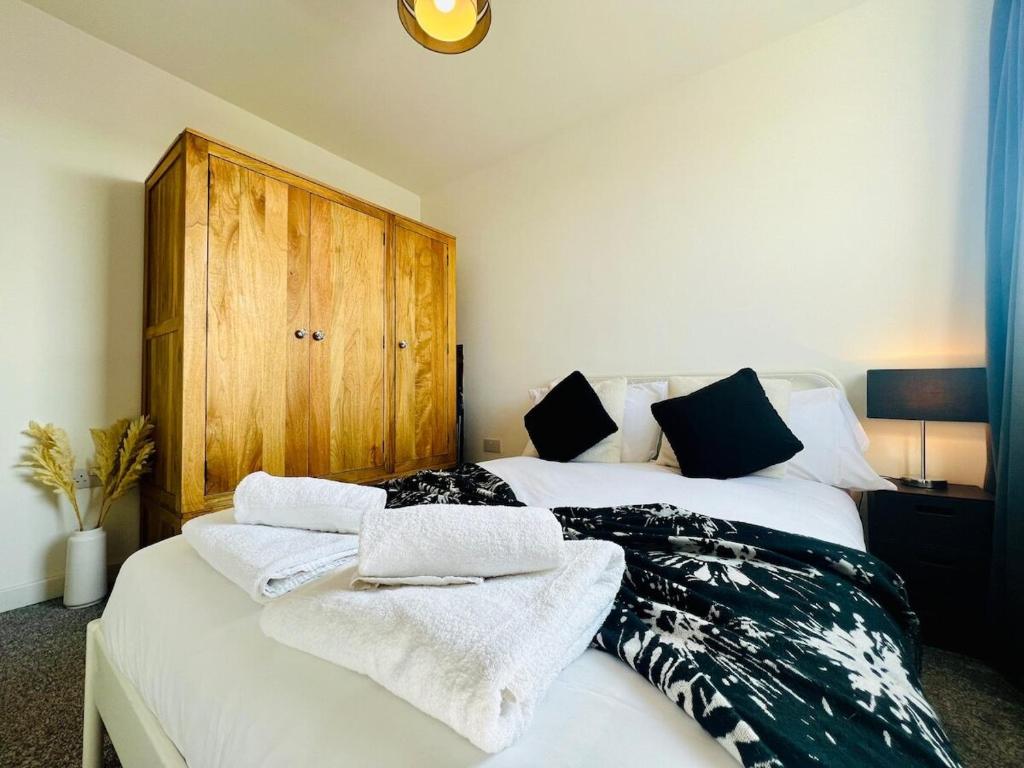 a bedroom with a bed with towels on it at 503 Focus Apartments in Ipswich