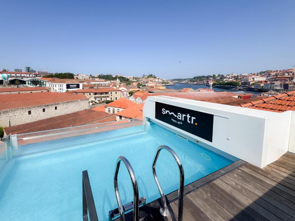 a swimming pool on the roof of a building at Smartr Porto Gaia & Spa in Vila Nova de Gaia