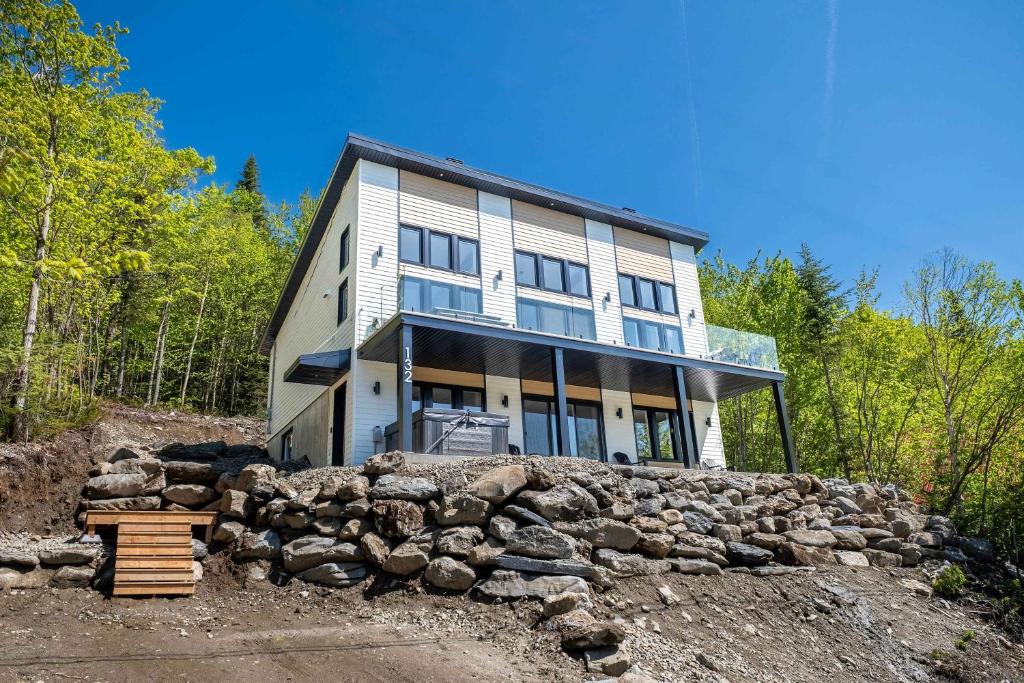 a large house on top of a rock wall at Spa Mountain Pool table - Le Haut 132 in Saint-Philémon