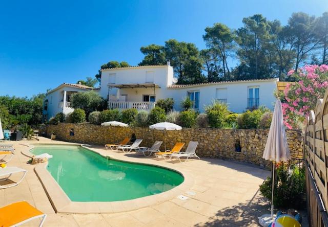a swimming pool in front of a house at Villa Nassalia in Lorgues