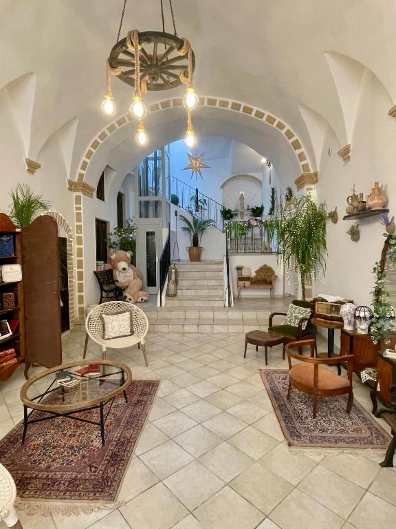 a large living room with tables and chairs at Calliope in Gallipoli
