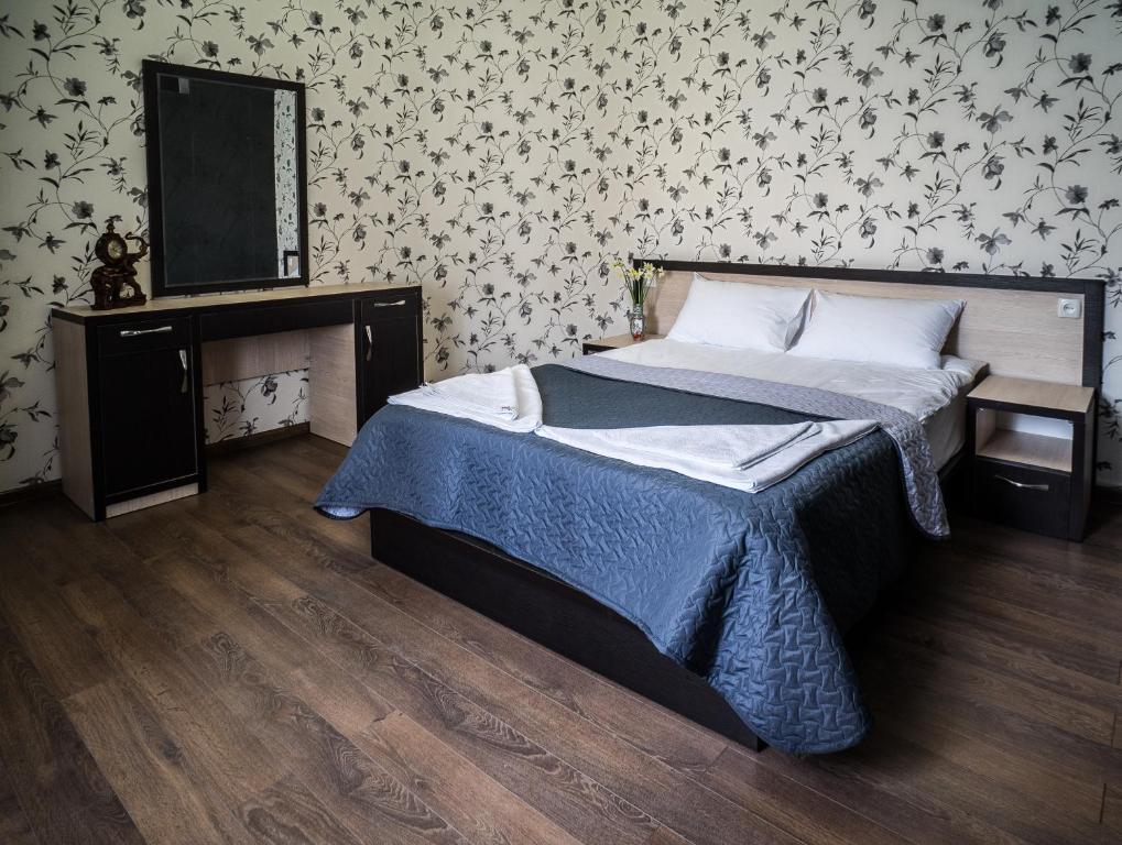 Postel nebo postele na pokoji v ubytování Hotel Tiflis