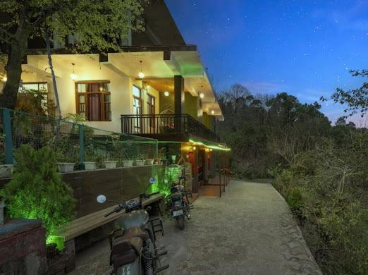 a house with bikes parked outside of it at night at The Starlight Hotel Kasauli in Dharampur