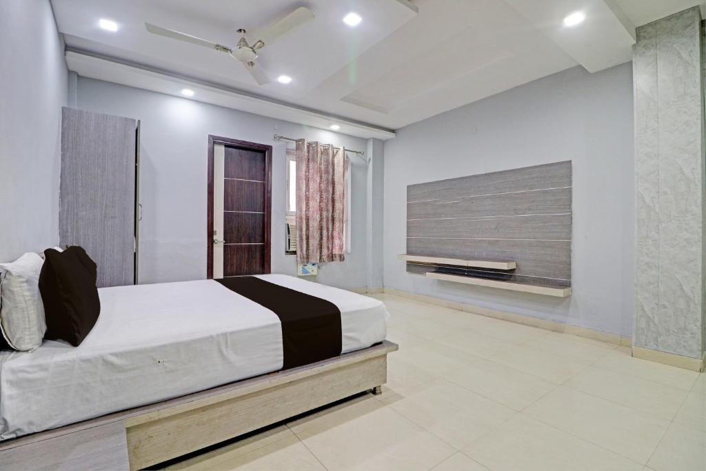 a bedroom with a large bed and a tv at Grand Townhouse in Palwal