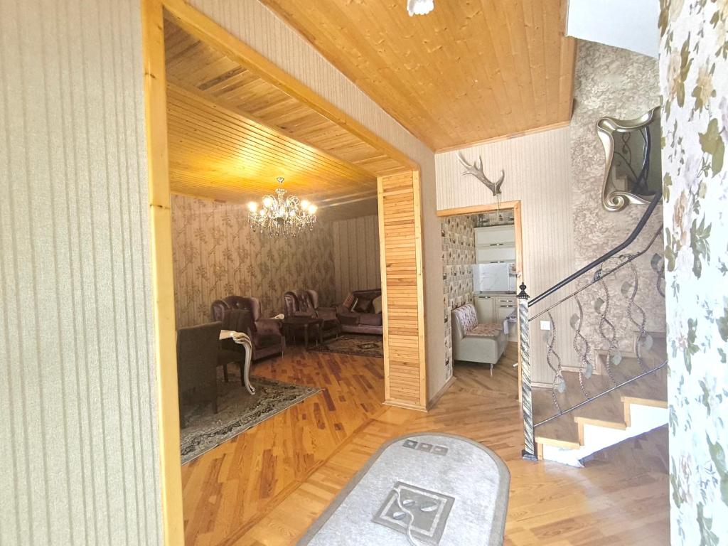 a living room with a stairway and a living room with at İsmayıllı dağın ətəyində kirayə ev in İsmayıllı