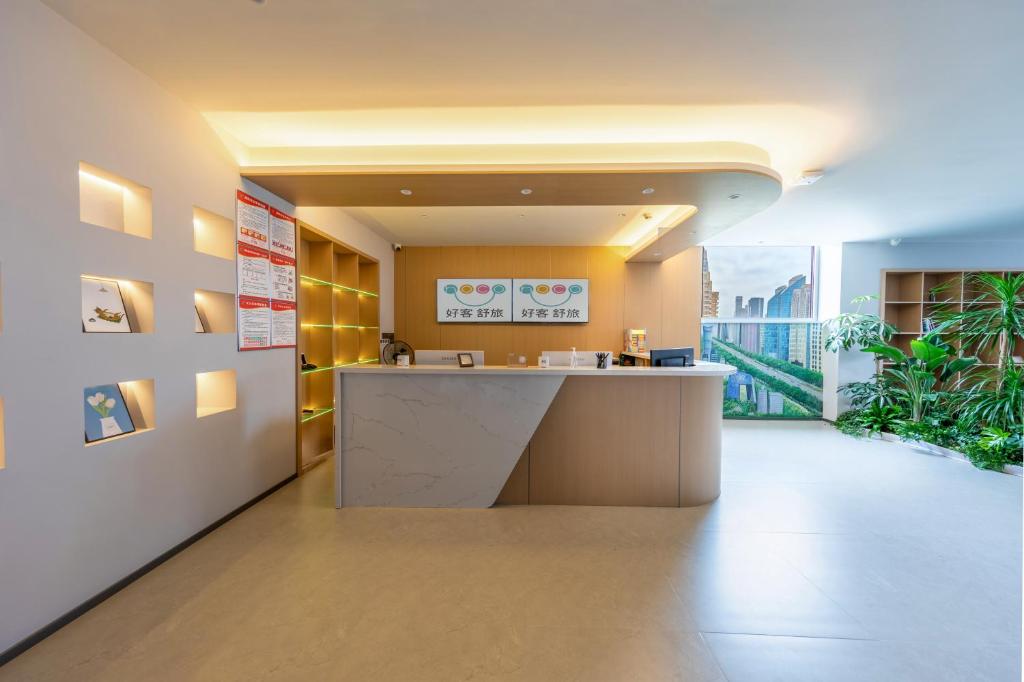 an office lobby with a counter and a large window at hoco in Beijing
