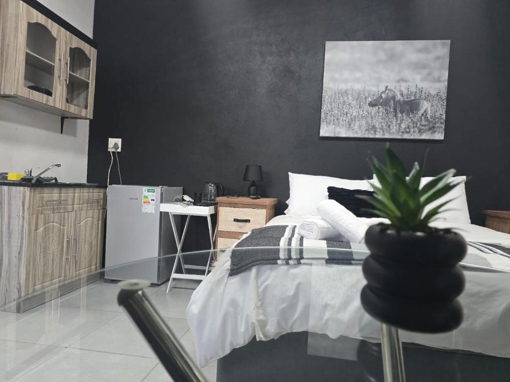 a bedroom with a bed with a potted plant on it at Moo Manor Flat 1 in Kimberley
