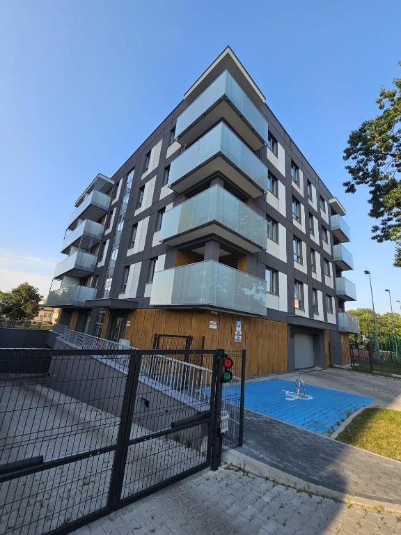 a building with a fence in front of it at LUXURY APARTMENTS WILCZA 8 by Marta klimatyzacja in Radom