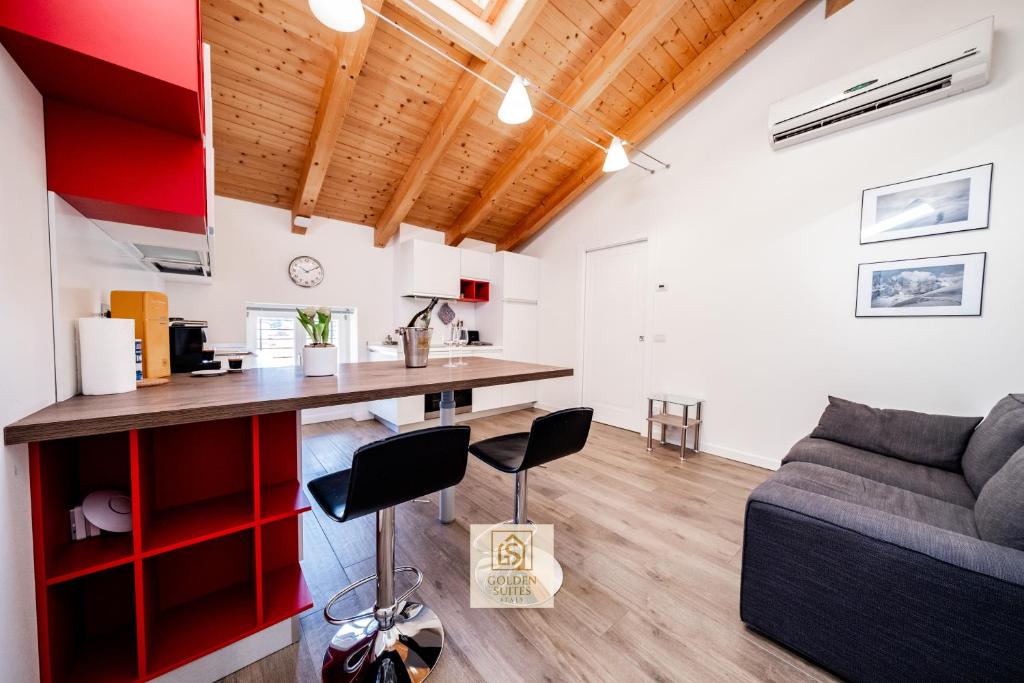 a living room with a couch and a table at GoldenSuitesItaly I Trento Duomo Suite 1 in Trento