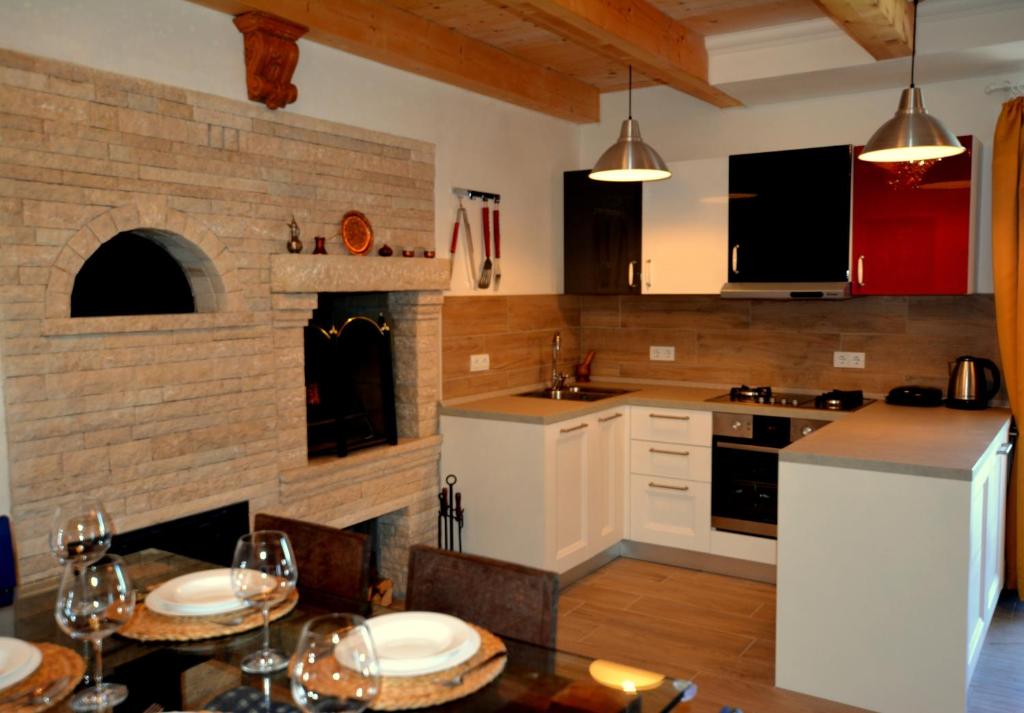 a kitchen with a table and a brick wall at Art House Vižinada in Vižinada