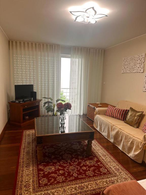 a living room with a couch and a coffee table at Azor International Apartment II in Ponta Delgada