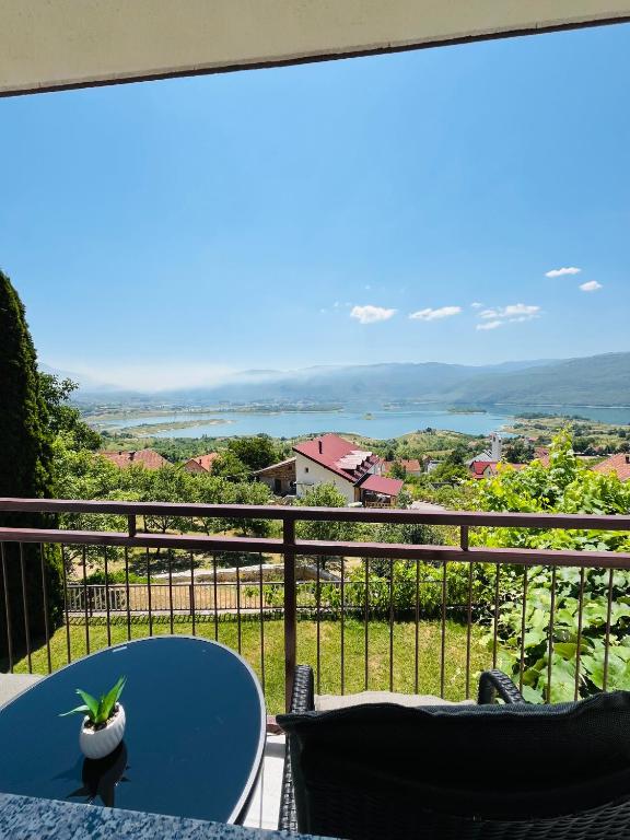 a table and chairs on a balcony with a view at Apartman Lucija in Rumboci