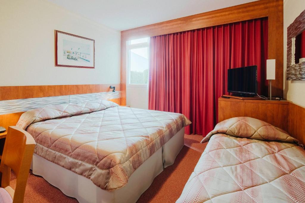 Voodi või voodid majutusasutuse Hôtel & Résidence Octel toas